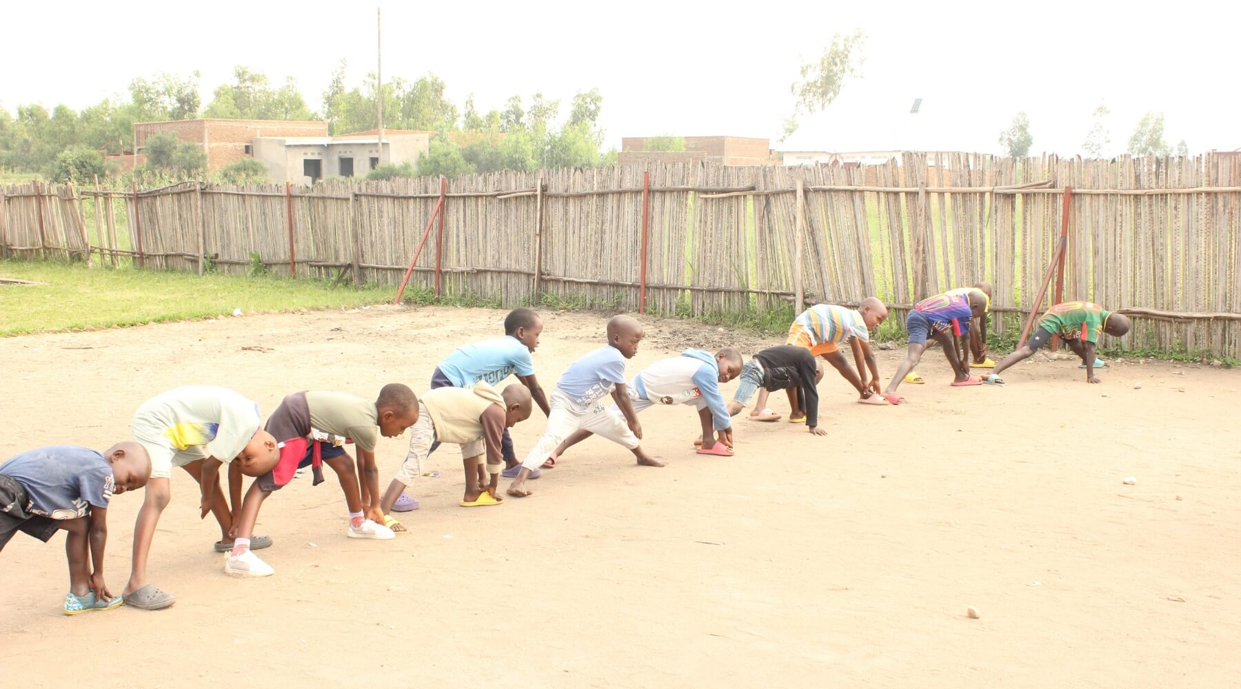 A line of students doing stretches outdoors 
