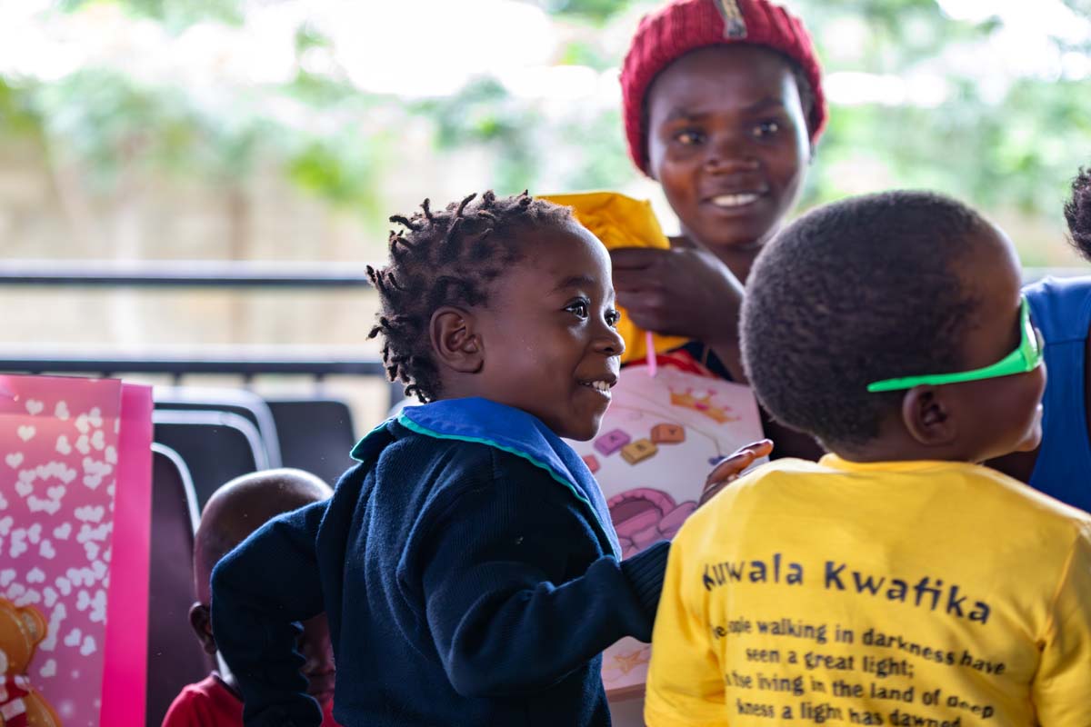 children smiling with an adult