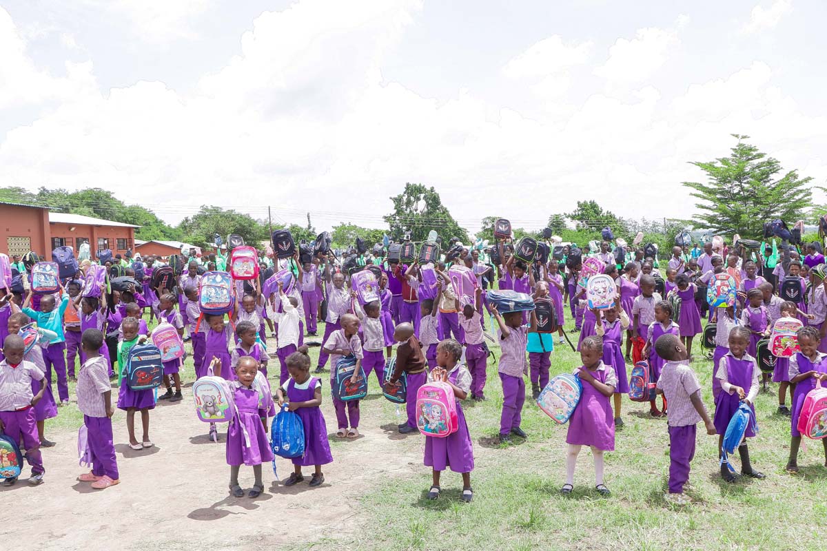Children smiling and opening their hope packs gifts