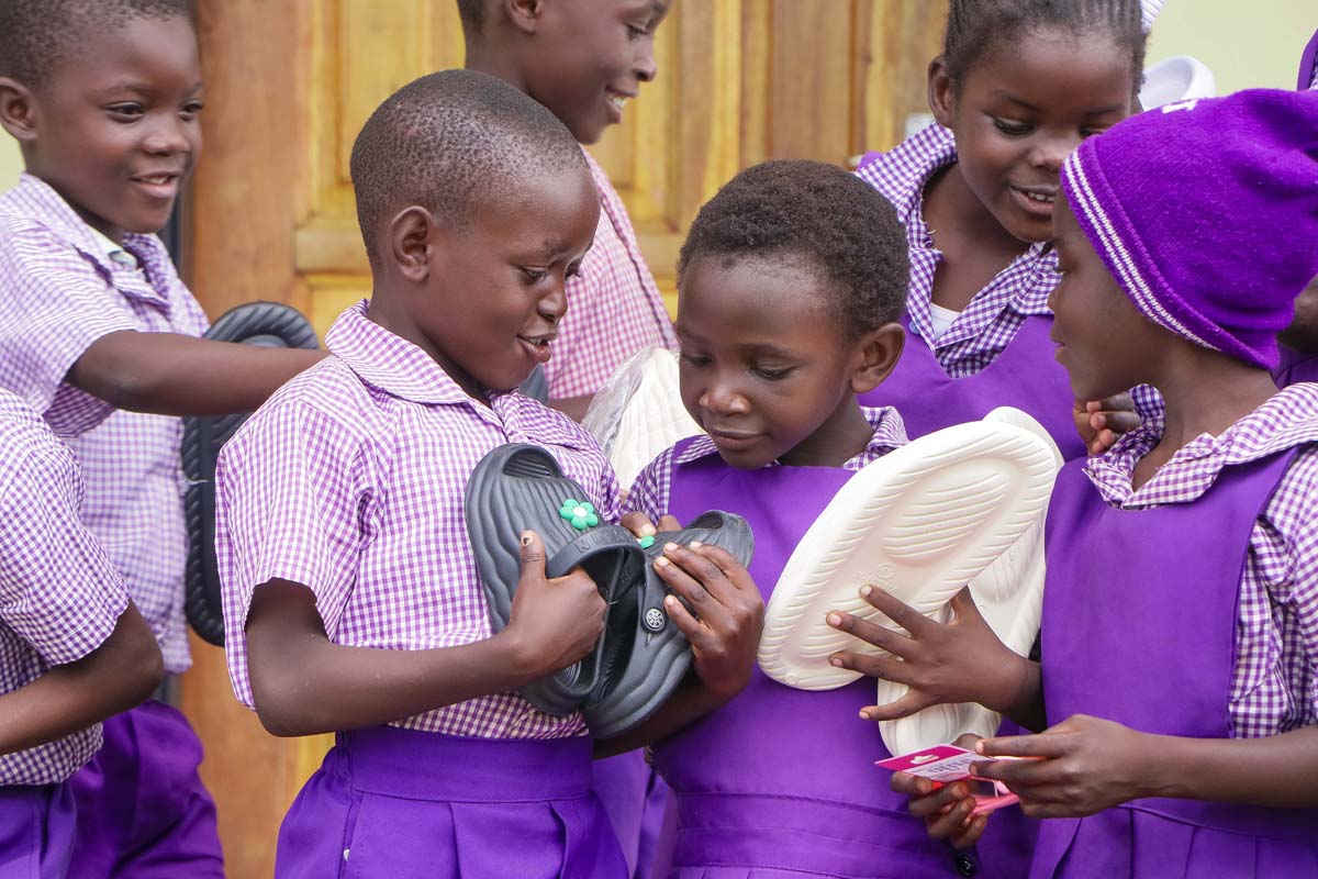 Children smiling and opening their hope packs gifts