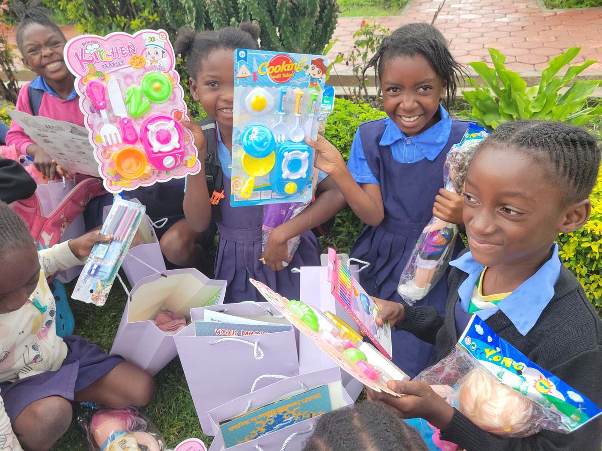 Children smiling and opening their hope packs gifts