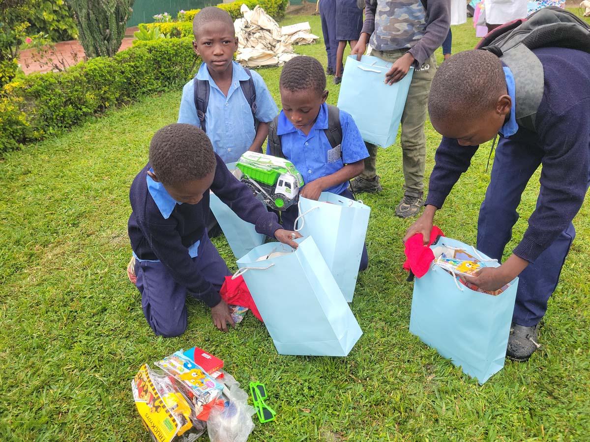 Children smiling and opening their hope packs gifts