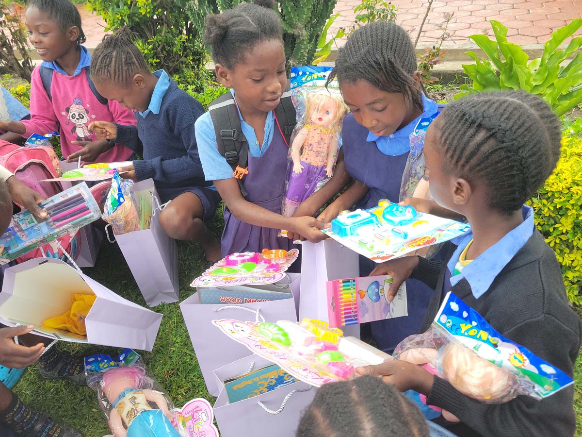 Children smiling and opening their hope packs gifts