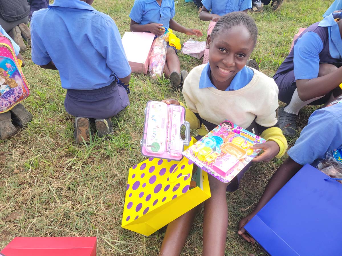 Girl holding a gift bag with gifts inside